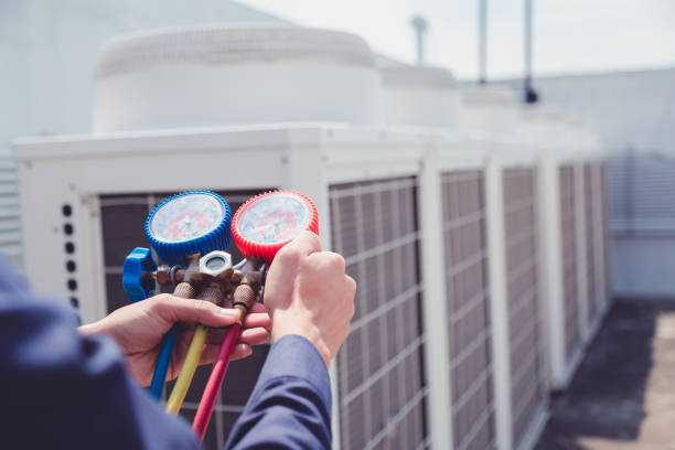Technician checking HVAC equipment with gauges